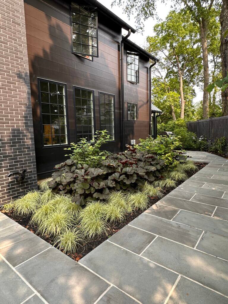 A stone pathway and plantings alongside it from a landscape design by Landbox Landscape Architecture Studio